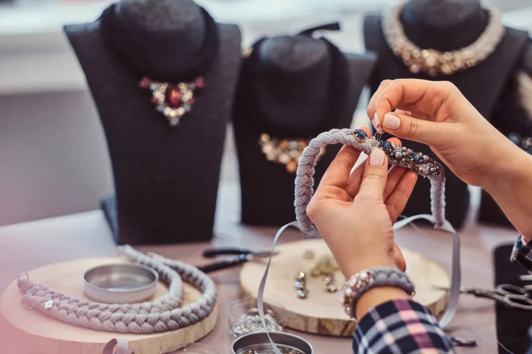 1-close-up-photo-woman-s-hands-who-makes-handmade-necklaces-working-with-needles-thread-jewelry-workshop